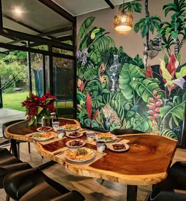 a wooden table with plates of food on it at Private Costa Rica Mountain House Pool & Stunning Views in Turrialba