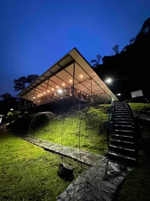 a building with a fence and stairs in a field at Private Costa Rica Mountain House Pool & Stunning Views in Turrialba