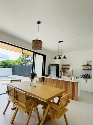 a kitchen with a wooden table and chairs in a room at Casa Paloma in Playa Grande