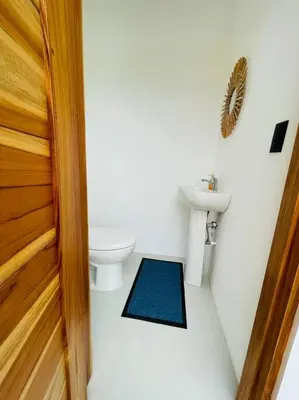 a bathroom with a toilet and a sink at Casa Paloma in Playa Grande