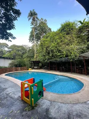 a small swimming pool with a play equipment in it at Hotel Brisas del Rio Guápiles in Jiménez