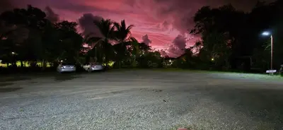 a parking lot at night with a cloudy sky at Hotel Canto de Ballenas in Uvita