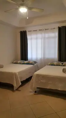 a bedroom with two beds and a ceiling fan at VillaLore piscina exclusiva BBQ AC max 11 personas 5min playas in Carpintero