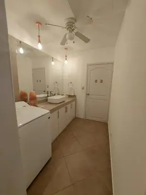 a white kitchen with two sinks and a ceiling fan at VillaLore piscina exclusiva BBQ AC max 11 personas 5min playas in Carpintero