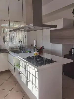 a kitchen with a sink and a stove top oven at VillaLore piscina exclusiva BBQ AC max 11 personas 5min playas in Carpintero
