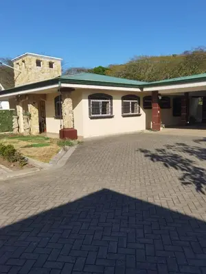a building with a brick driveway in front of it at VillaLore piscina exclusiva BBQ AC max 11 personas 5min playas in Carpintero