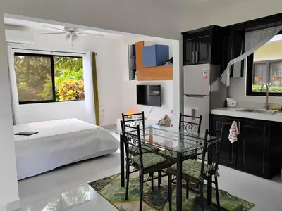 a bedroom with a bed and a glass table and chairs at Sweet Torres Estudio 2pers in Coco