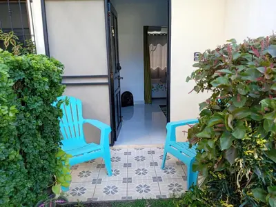 two blue chairs sitting on the porch of a house at Sweet Torres Estudio 2pers in Coco