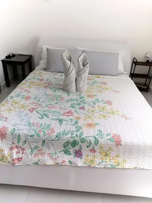 two white shoes sitting on top of a bed at Sweet Torres Estudio 2pers in Coco
