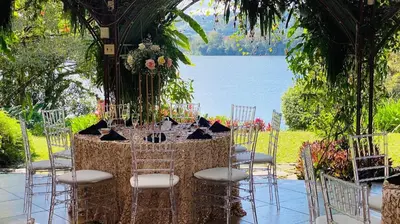 a table set up for a wedding by the water at Hotel Boutique Casona del Cafetal and Lakeside Restaurant in Cachí