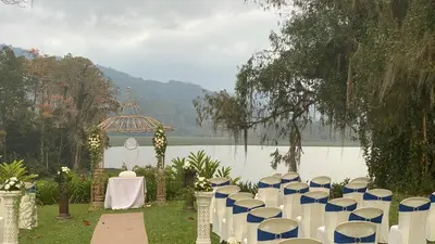 a set up for a wedding in front of a lake at Hotel Boutique Casona del Cafetal and Lakeside Restaurant in Cachí