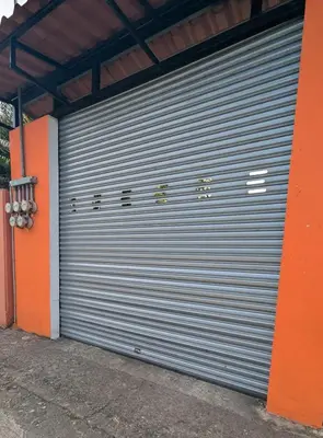a metal garage door with the word garage on it at Alicama in Puerto Limón