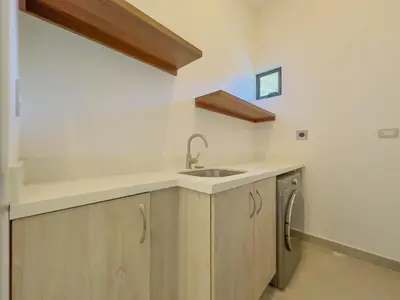 a kitchen with wooden cabinets and a sink at Coco Luna House 2 bed 3 bath in Coco