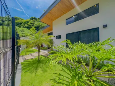 a house with a fence and plants in front of it at Coco Luna House 2 bed 3 bath in Coco
