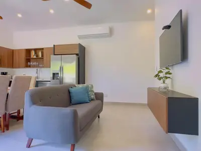 a living room with a couch and a tv at Coco Luna House 2 bed 3 bath in Coco
