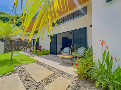 a house with two chairs and a table in front of it at Coco Luna House 2 bed 3 bath in Coco