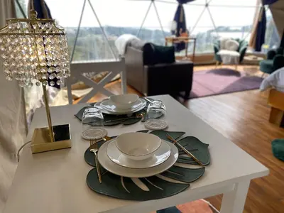 a table with plates and utensils on top of it at FERNANDA Dome at FéLIZA Rainforest Domes in Monteverde Costa Rica