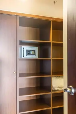 a closet with a book shelf with a microwave at 3 Bedroom Condo in Croc's Casino Resort in Jacó
