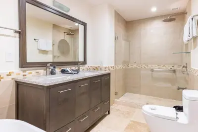 a bathroom with a sink and a toilet and a mirror at 3 Bedroom Condo in Croc's Casino Resort in Jacó