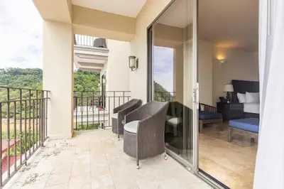 a balcony with a view of a bedroom at 3 Bedroom Condo in Croc's Casino Resort in Jacó