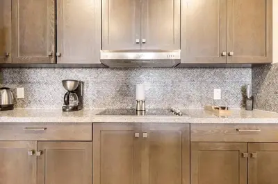a kitchen with wooden cabinets and a sink at 3 Bedroom Condo in Croc's Casino Resort in Jacó