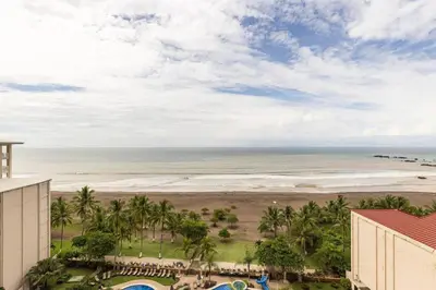 a view of the beach from the balcony of a resort at 3 Bedroom Condo in Croc's Casino Resort in Jacó