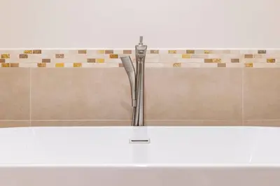 a shower curb with a toothbrush in a bathroom at 3 Bedroom Condo in Croc's Casino Resort in Jacó