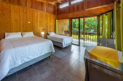 a bedroom with two beds and a balcony at Campo Verde B&B - Monteverde Costa Rica in Monteverde Costa Rica