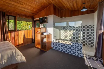 a bedroom with a bed and a room with a window at Campo Verde B&B - Monteverde Costa Rica in Monteverde Costa Rica