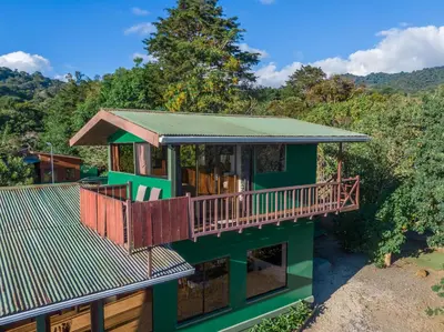 a house with a green roof with a deck at Campo Verde B&B - Monteverde Costa Rica in Monteverde Costa Rica