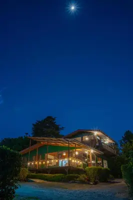 a large glass building with the moon in the sky at Campo Verde B&B - Monteverde Costa Rica in Monteverde Costa Rica