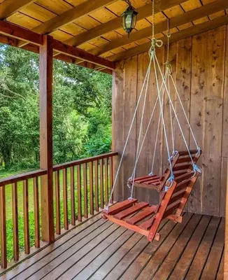 a swing on the porch of a cabin at Campo Verde B&B - Monteverde Costa Rica in Monteverde Costa Rica