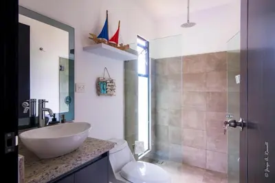 a bathroom with a sink and a toilet and a shower at Casa para Vacacionar Increible en Bejuco in Loma