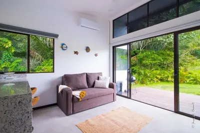 a living room with a couch and a sliding glass door at Casa para Vacacionar Increible en Bejuco in Loma