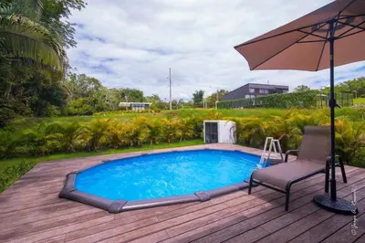 a pool on a deck with a chair and an umbrella at Casa para Vacacionar Increible en Bejuco in Loma