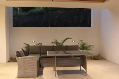 a living room with a couch and a painting on the wall at Playa Conchal and Minas' Hidden Gem in Puerto Viejo