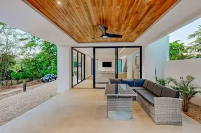 a living room with a couch and a ceiling fan at Playa Conchal and Minas' Hidden Gem in Puerto Viejo