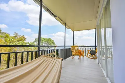 a hammock on the balcony of a house at Nosara Hideaway 1 - Mountain View Cabins & BREAKFAST PROVIDED in Naranjal