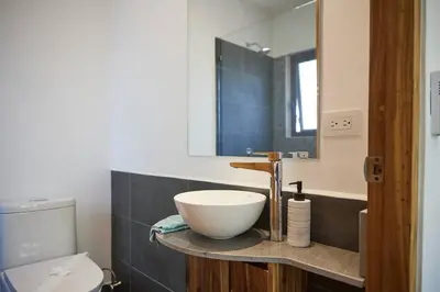 a bathroom with a bowl sink and a toilet at Green Turtle Townhome #2 Private Pool & Garden 300 Mtrs to Beach in Tamarindo