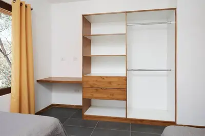 a bedroom with a book shelf and a bed at Green Turtle Townhome #2 Private Pool & Garden 300 Mtrs to Beach in Tamarindo