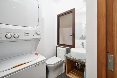 a bathroom with a white toilet and a sink at Green Turtle Townhome #3 Private Pool & Garden 300 Mt to Beach in Tamarindo