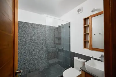 a bathroom with a shower and a toilet and a sink at Green Turtle Townhome #3 Private Pool & Garden 300 Mt to Beach in Tamarindo