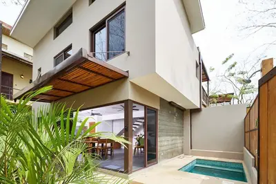 a house with a swimming pool in front of it at Green Turtle Townhome #4 Private Pool & Garden 300Mtrs to Beach in Tamarindo