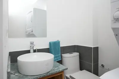 a white bathroom with a sink and a toilet at Green Turtle Townhome #4 Private Pool & Garden 300Mtrs to Beach in Tamarindo