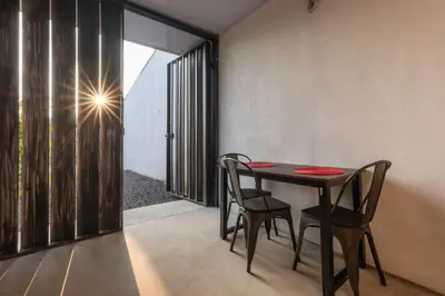 a dining room with a table and two chairs at Zen Studio in Jacó