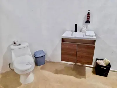 a bathroom with a toilet and a sink at Zen Studio in Jacó