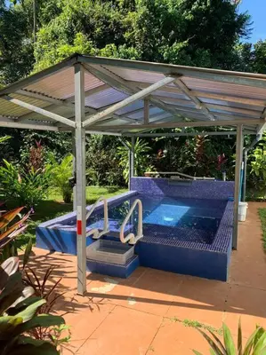 a swimming pool under a pavilion with a swimming pool at Ojochal maison moderne piscine creusée in Ojochal