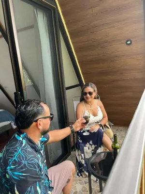 a man and a woman holding a glass of wine at Small Country House in Monterrey