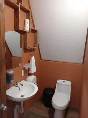 a bathroom with a toilet and a sink at Small Country House in Monterrey
