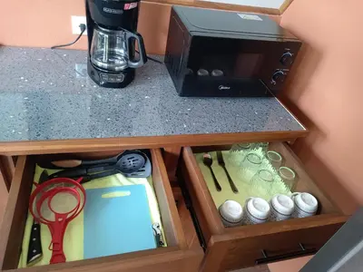 a counter top with a cupboard with a coffee maker at Small Country House in Monterrey